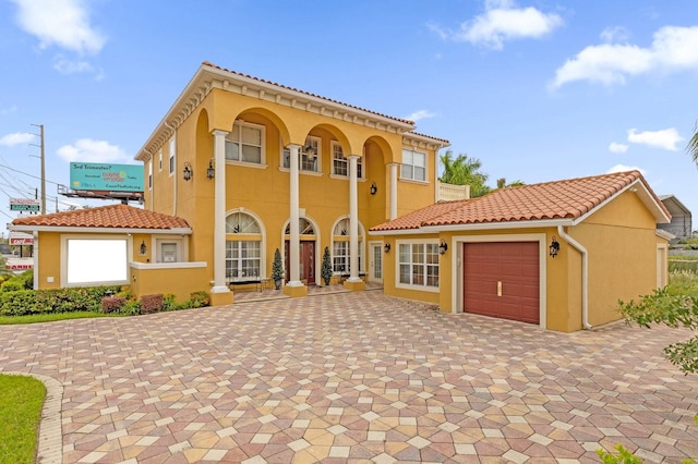 mediterranean / spanish home featuring a garage