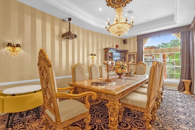 dining space with a tray ceiling and a chandelier