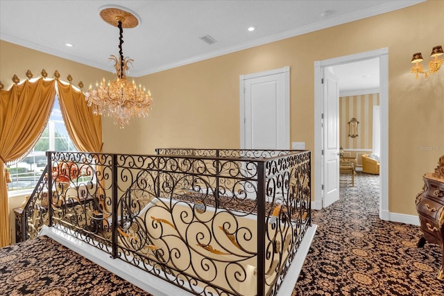 hall with carpet flooring, a chandelier, and ornamental molding