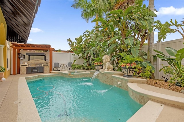 view of pool featuring pool water feature and exterior kitchen