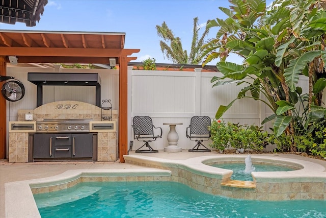 view of pool featuring an outdoor kitchen and grilling area