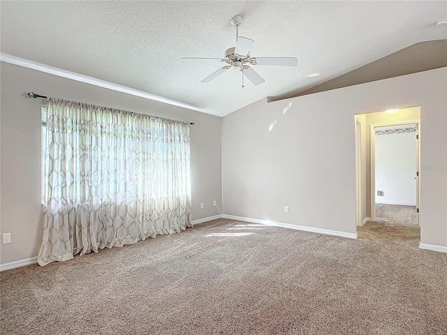 empty room featuring carpet flooring, a textured ceiling, ceiling fan, and lofted ceiling