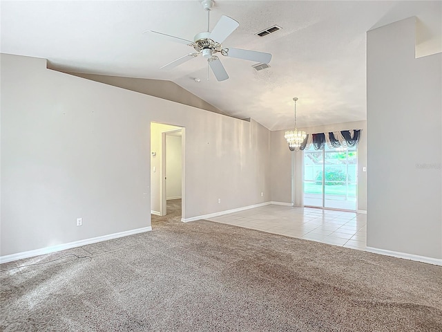 carpeted empty room featuring ceiling fan with notable chandelier and lofted ceiling