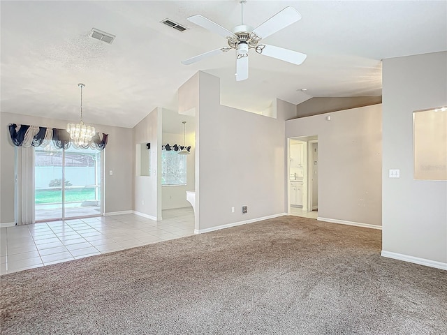 spare room with ceiling fan with notable chandelier, light colored carpet, and lofted ceiling