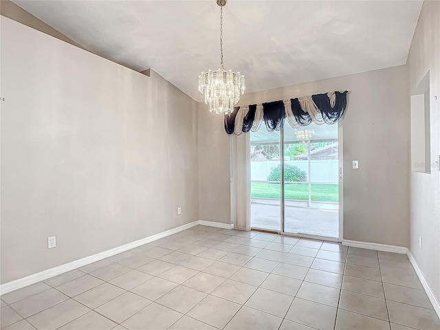 tiled empty room with a chandelier