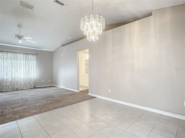 empty room featuring ceiling fan with notable chandelier, light colored carpet, lofted ceiling, and a textured ceiling