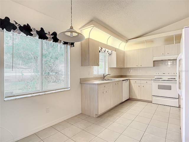 kitchen featuring a textured ceiling, white appliances, sink, decorative light fixtures, and lofted ceiling