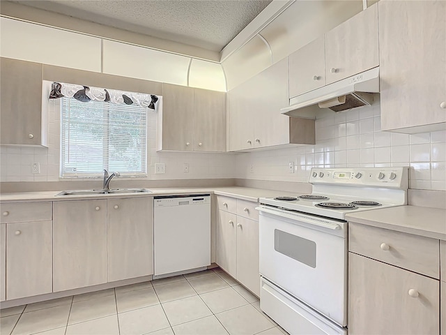 kitchen with sink, tasteful backsplash, a textured ceiling, white appliances, and light tile patterned flooring