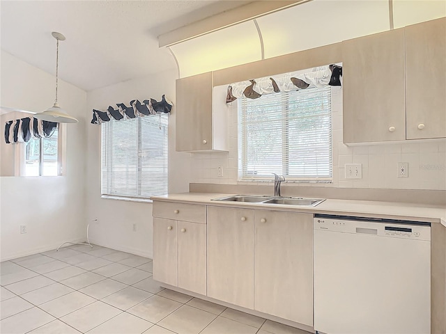 kitchen with sink, white dishwasher, decorative light fixtures, and plenty of natural light