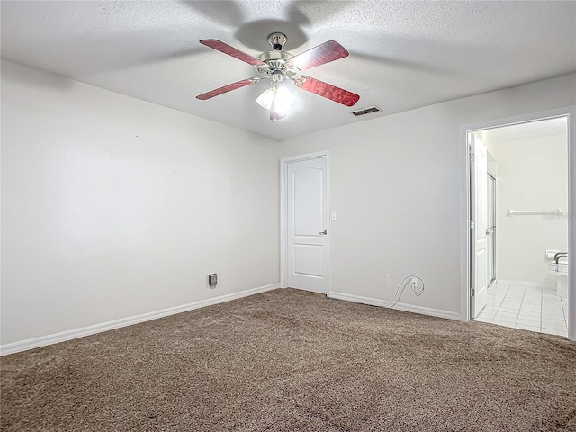 unfurnished bedroom featuring ceiling fan, ensuite bathroom, light carpet, and a textured ceiling