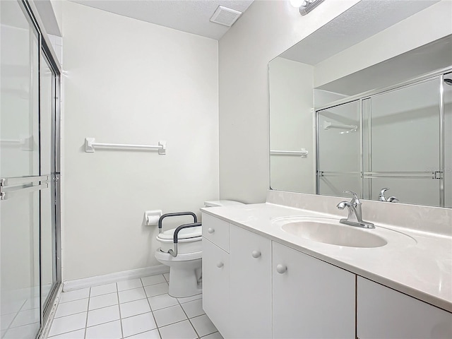 bathroom featuring tile patterned floors, a shower with door, vanity, and toilet