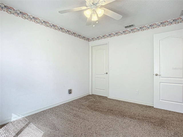 carpeted empty room featuring a textured ceiling and ceiling fan