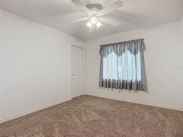 carpeted spare room featuring ceiling fan and a textured ceiling