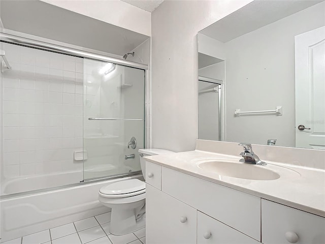 full bathroom with tile patterned floors, vanity, bath / shower combo with glass door, and toilet