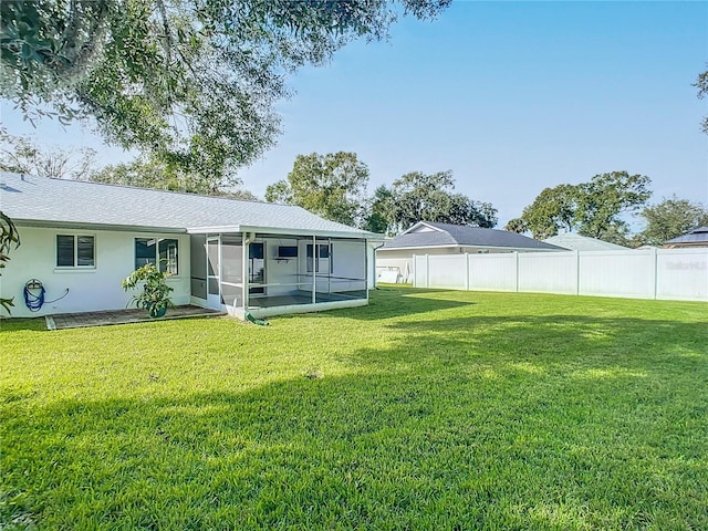 back of house featuring a sunroom and a yard