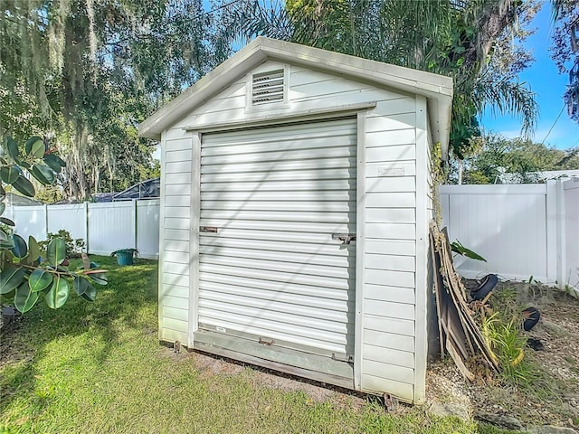 view of outdoor structure featuring a lawn