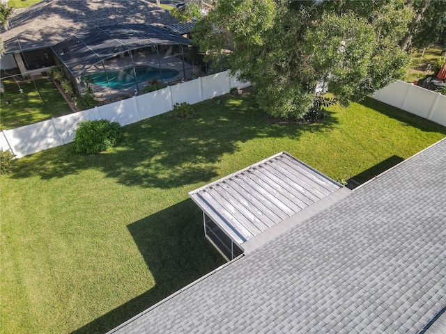 exterior space featuring a fenced in pool and a lanai