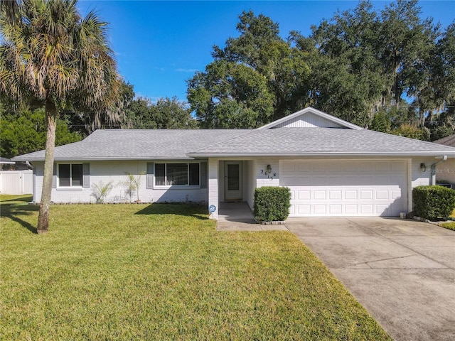 ranch-style home with a garage and a front yard