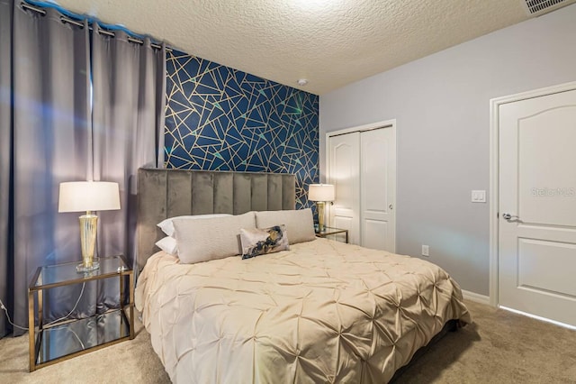 bedroom with carpet flooring, a closet, and a textured ceiling