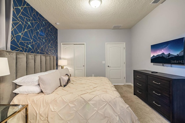 7400 Oakmoss Loop, Davenport, FL 33837 - bedroom featuring a textured ceiling, light colored carpet, and a closet