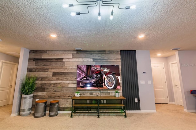 carpeted cinema with a textured ceiling and wood walls