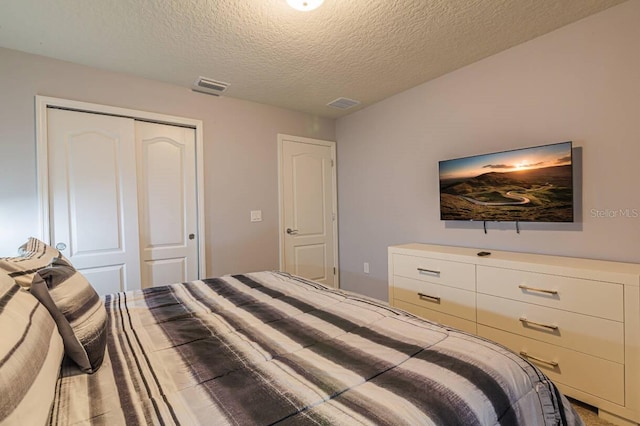 bedroom with a closet and a textured ceiling