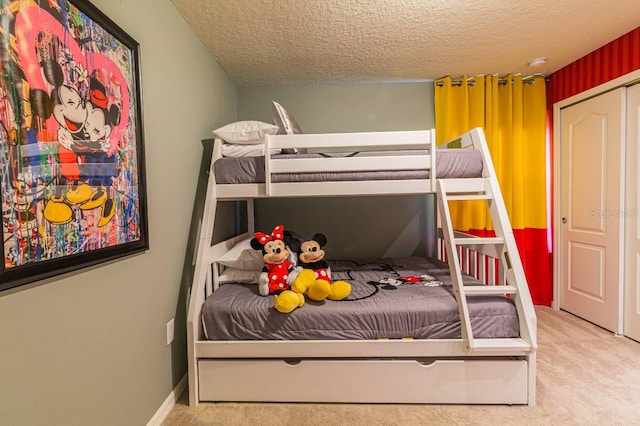 bedroom with carpet flooring, a closet, and a textured ceiling