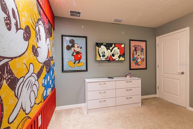 carpeted bedroom featuring a textured ceiling