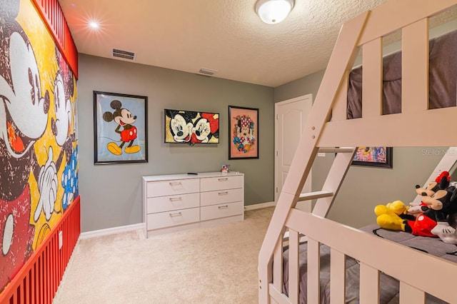 carpeted bedroom featuring a textured ceiling