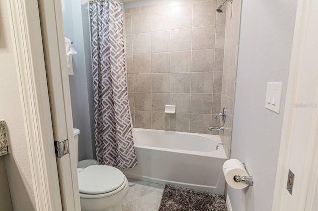 bathroom with tile patterned floors, shower / tub combo with curtain, and toilet