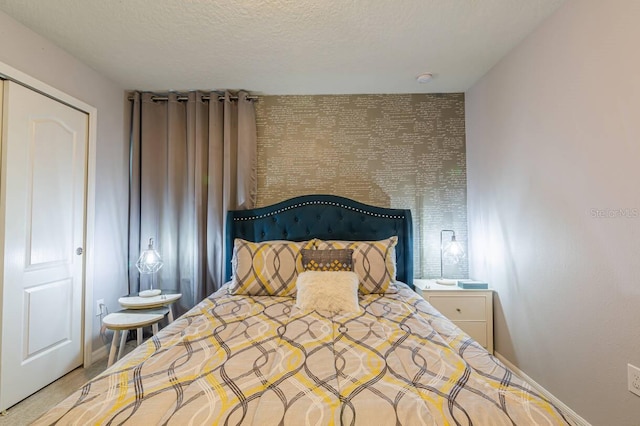 bedroom with a closet and a textured ceiling