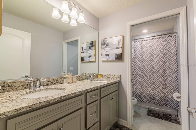 bathroom featuring a shower with curtain, vanity, a textured ceiling, tile patterned flooring, and toilet