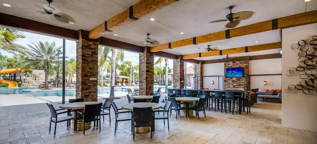 7400 Oakmoss Loop, Davenport, FL 33837 - dining room featuring beam ceiling, a ceiling fan, and ornate columns