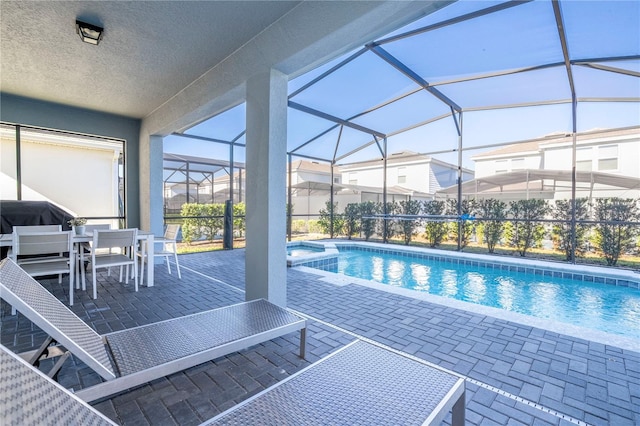 view of pool featuring a grill, a lanai, and a patio