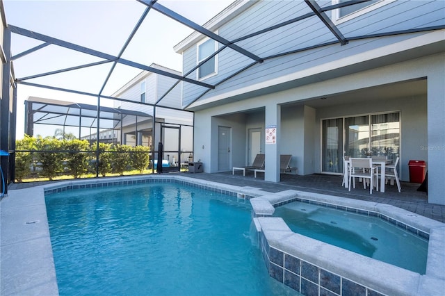 view of swimming pool with a lanai, a patio area, and an in ground hot tub