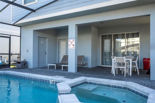 view of pool featuring a lanai, an in ground hot tub, and a patio