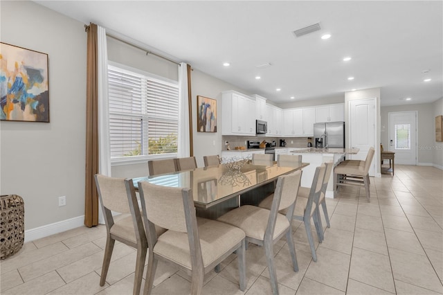 tiled dining area featuring plenty of natural light