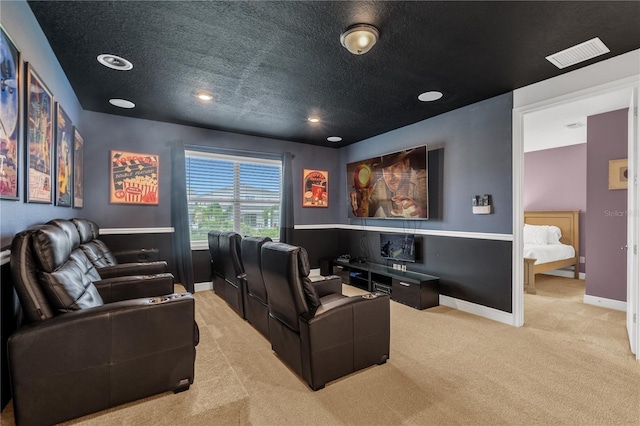 carpeted cinema room featuring a textured ceiling