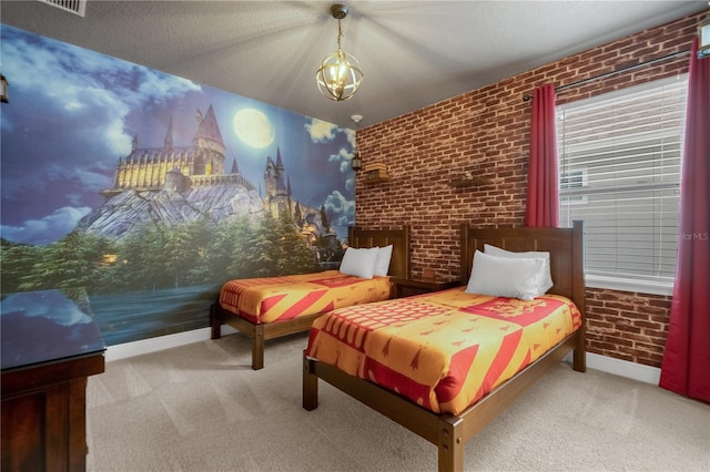 carpeted bedroom with a textured ceiling and brick wall