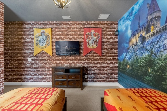 unfurnished bedroom with carpet flooring, a textured ceiling, and brick wall