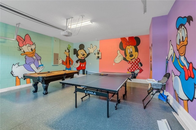 playroom with electric panel, a textured ceiling, and billiards