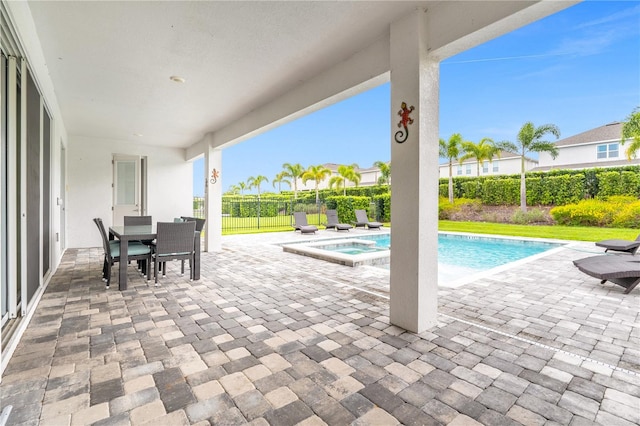 view of swimming pool featuring an in ground hot tub and a patio