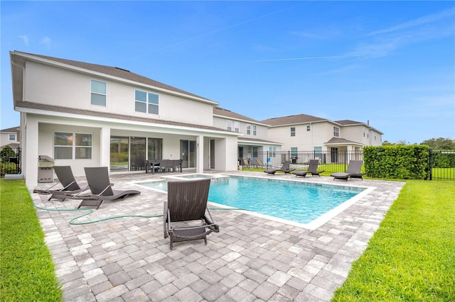 view of swimming pool with a patio area and a yard