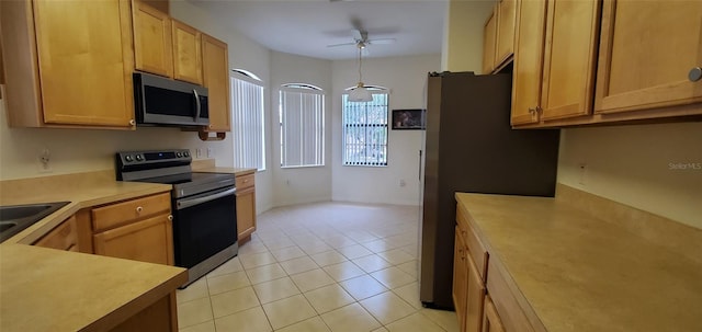 kitchen featuring stainless steel appliances, ceiling fan, light brown cabinets, decorative light fixtures, and light tile patterned flooring