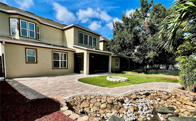 back of house with a patio area and a yard