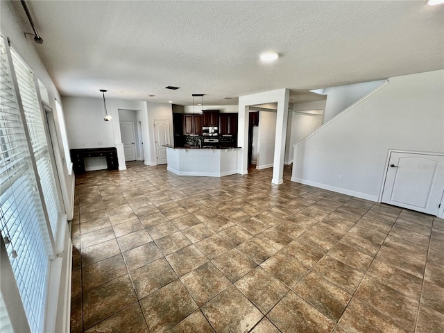 unfurnished living room featuring a textured ceiling