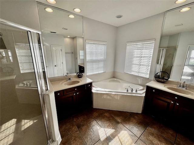 bathroom with shower with separate bathtub and vanity