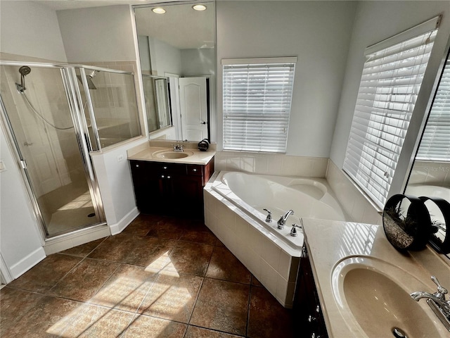 bathroom with tile patterned floors, vanity, and shower with separate bathtub