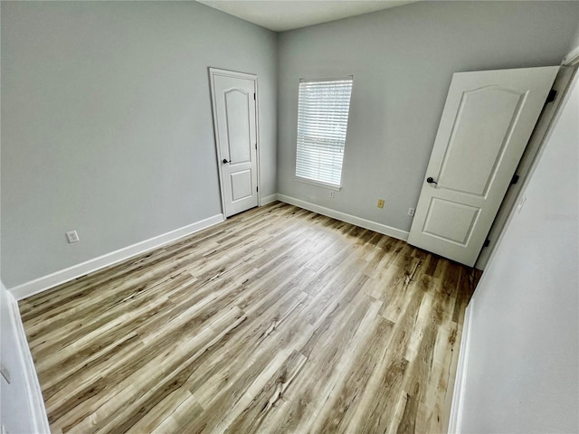 unfurnished bedroom with light wood-type flooring