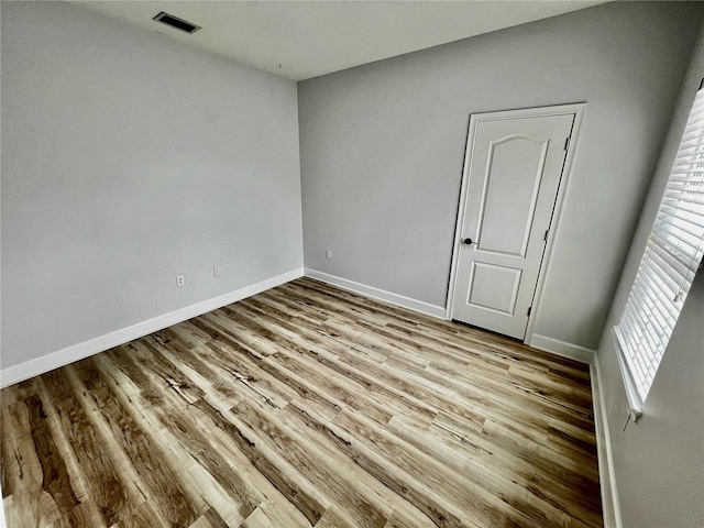 spare room featuring light hardwood / wood-style flooring